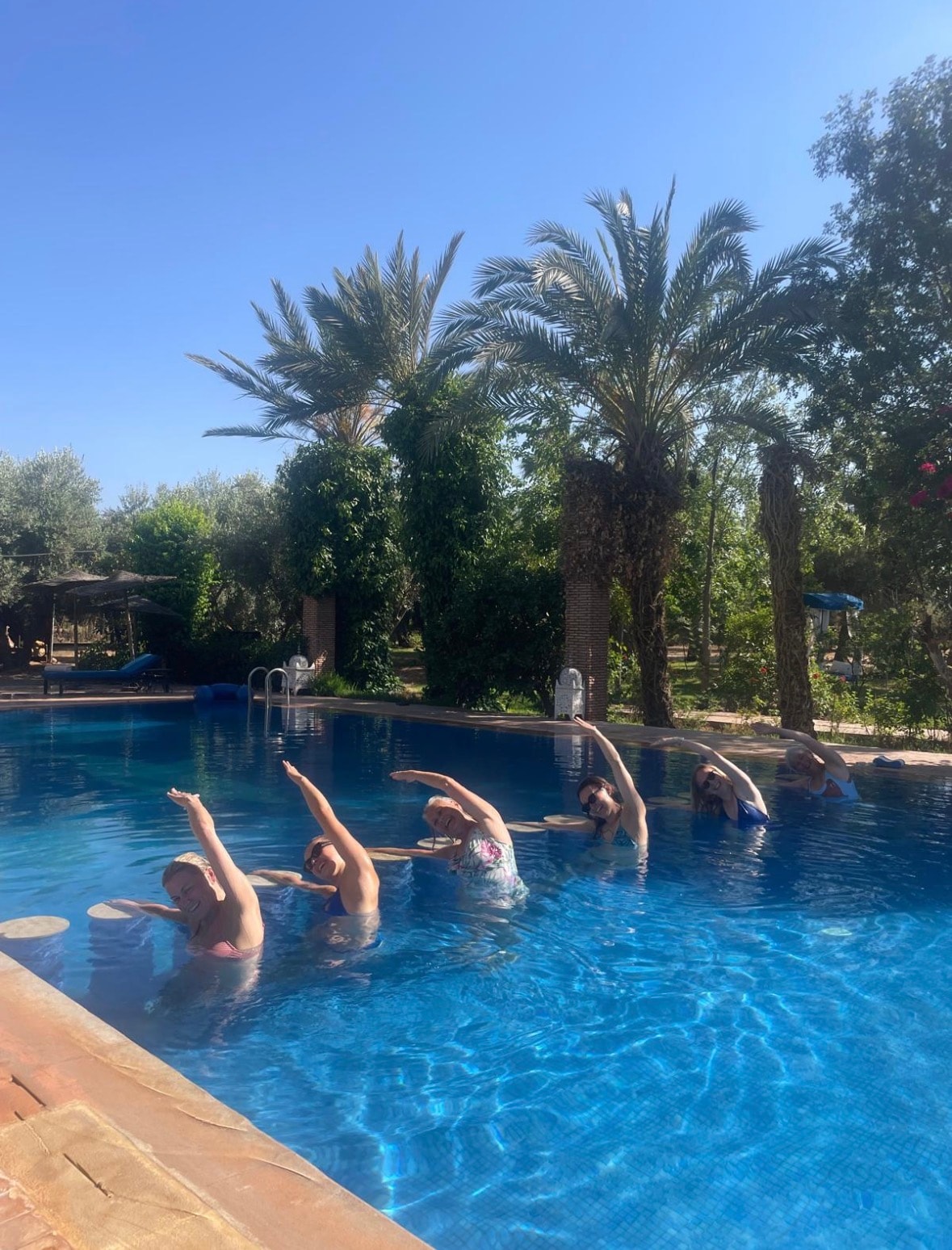 Team exercise class in the pool at a Four Sides retreat