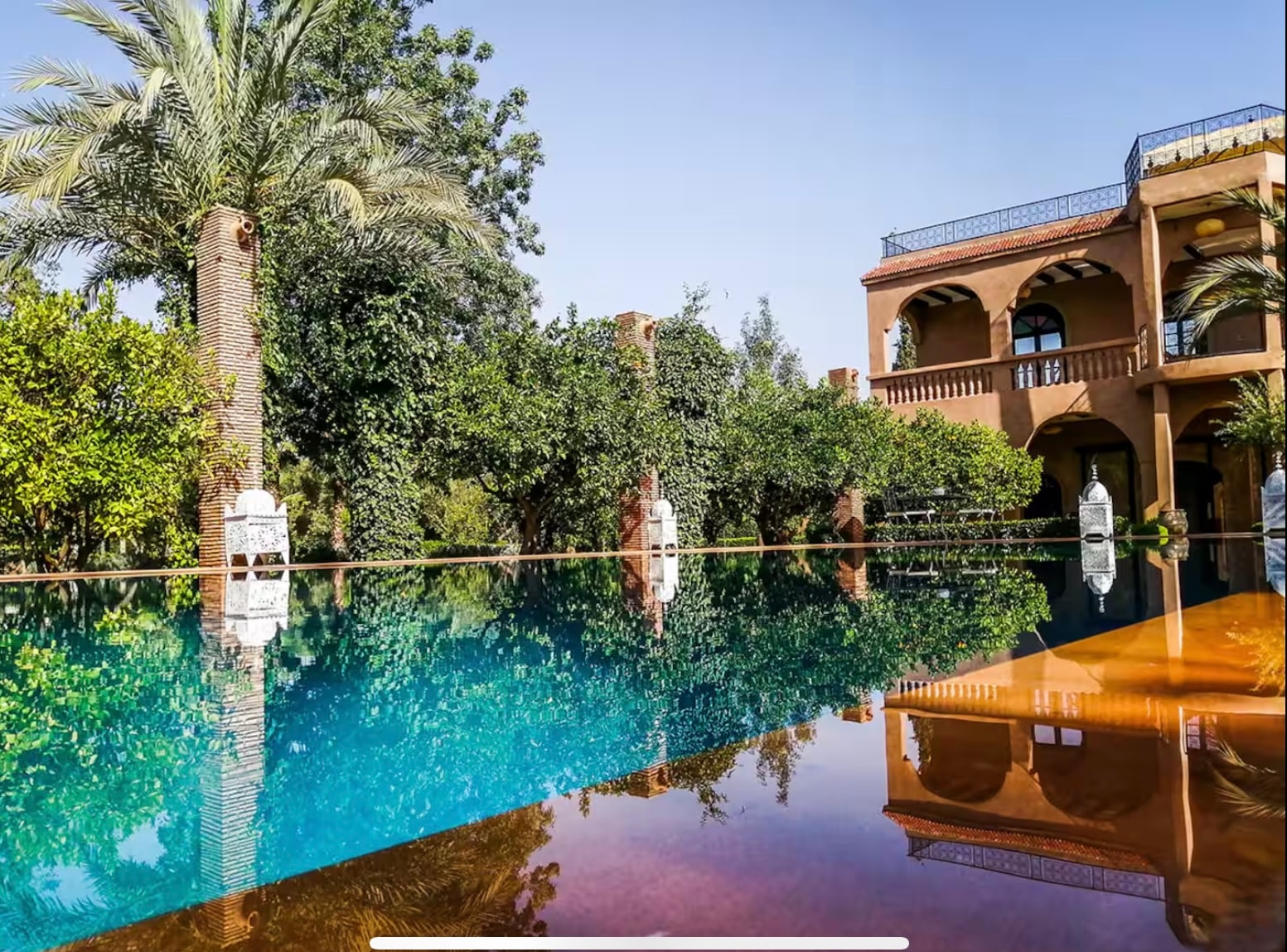 Riad pool with reflections and lush gardens