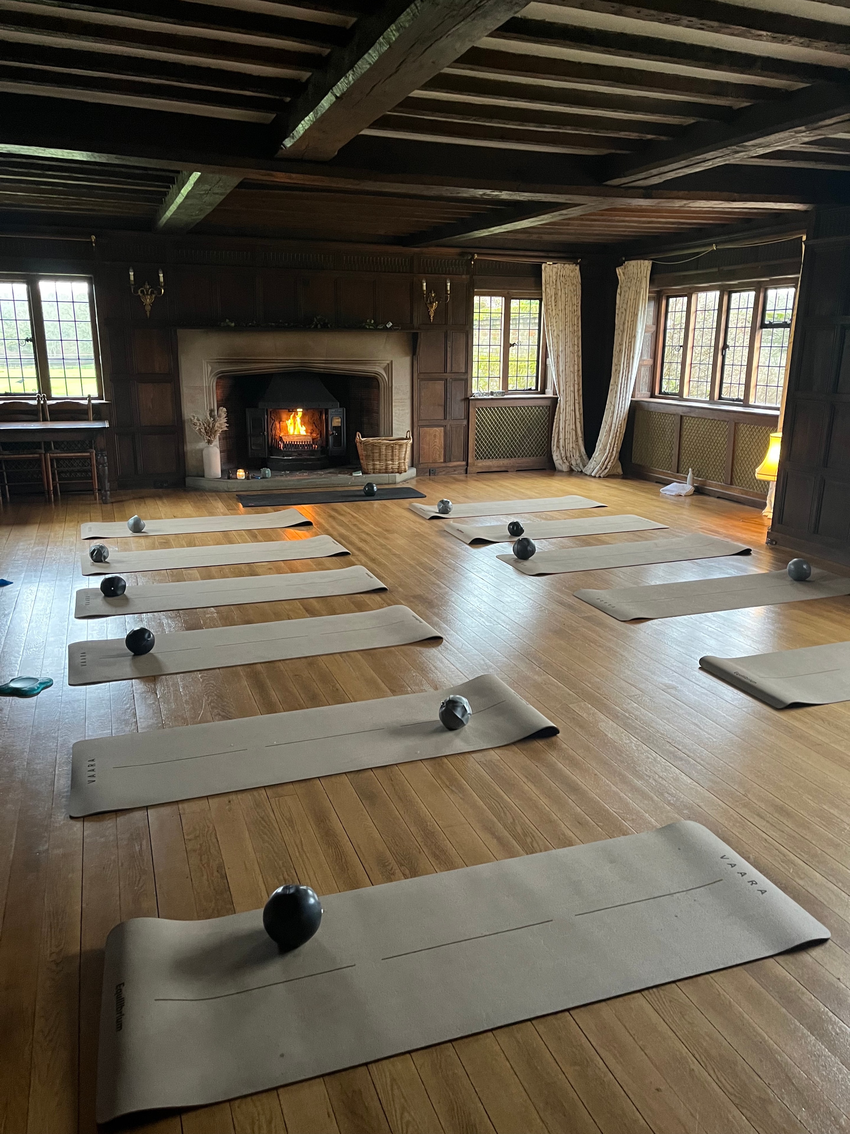 Yoga studio with open fireplace and mats laid out